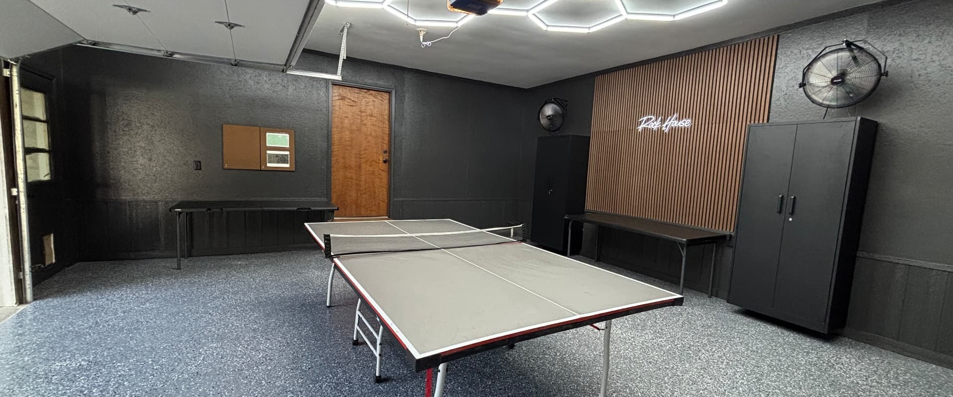 Premium organized garage with epoxy floor, storage systems, and LED lighting